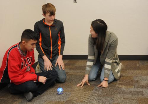 Students using an app based coding system to control the sphero robot.